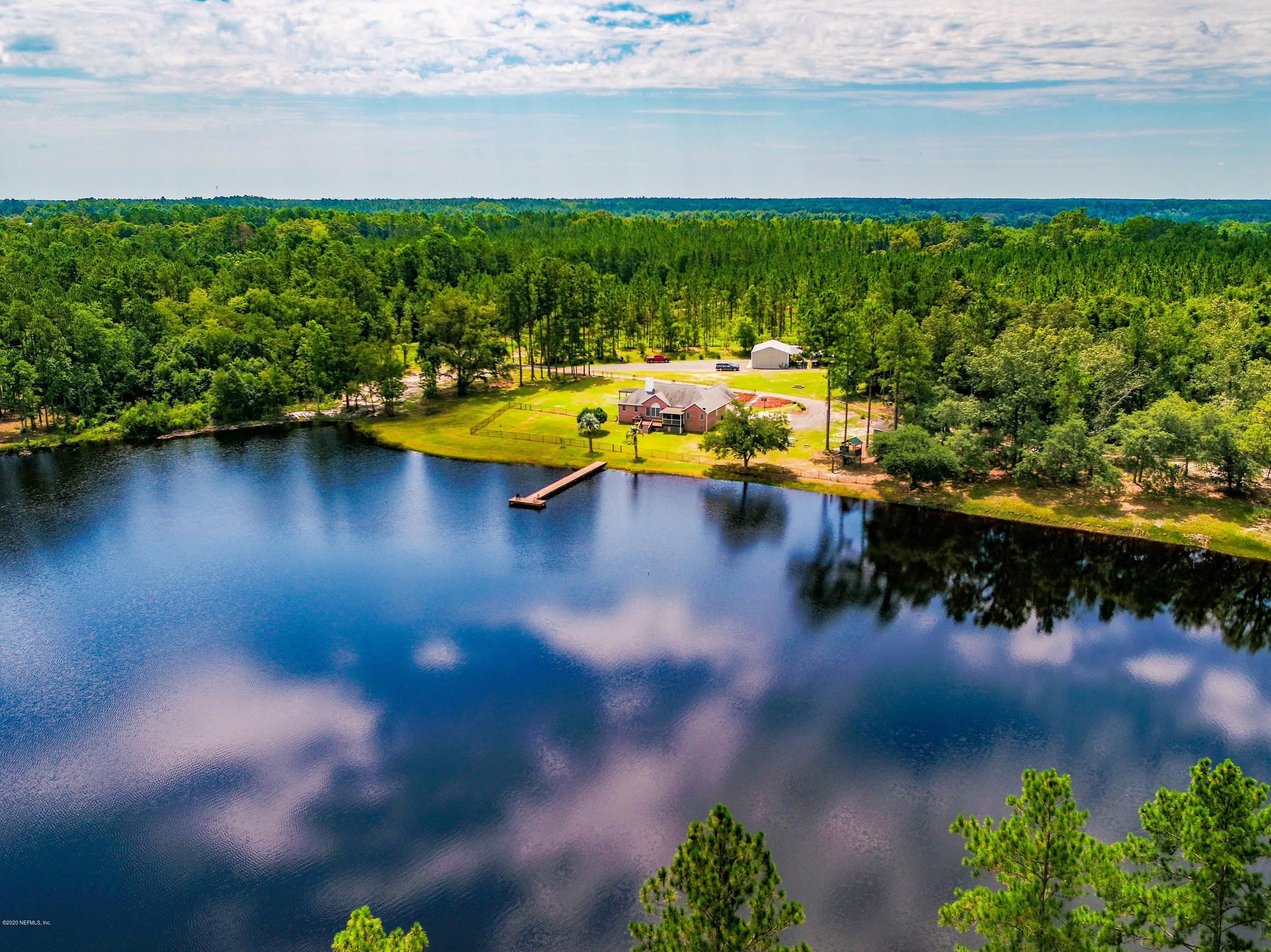 18261 Antler Road Hilliard, FL 32046 - Photo 1 of 32 a view of a lake with a yard