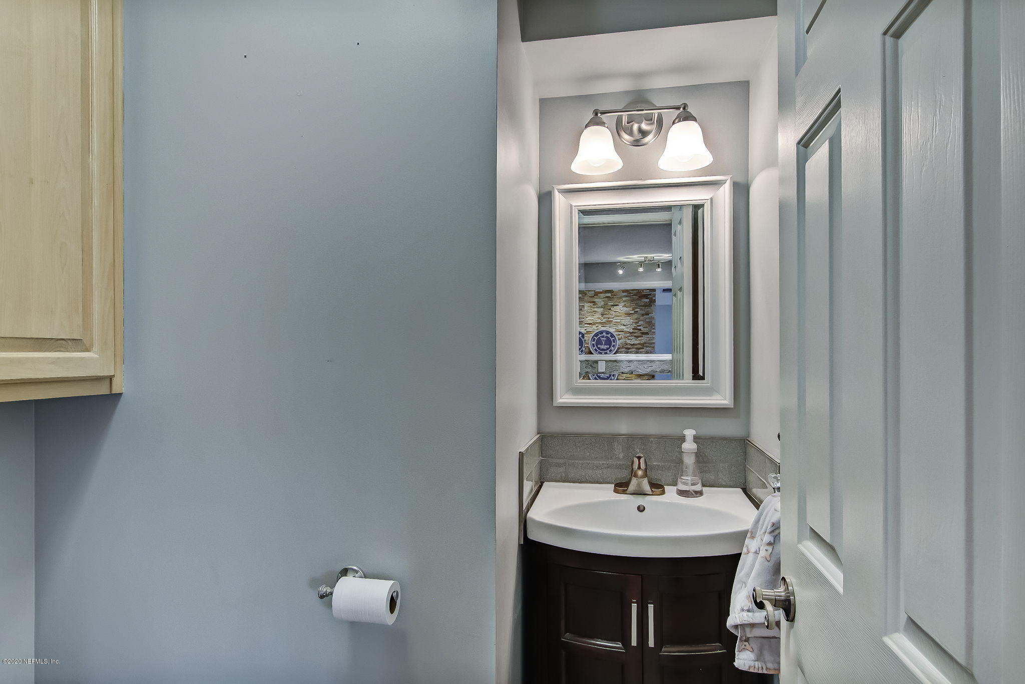 18261 Antler Road Hilliard, FL 32046 - Photo 13 of 32 a bathroom with a sink and a mirror