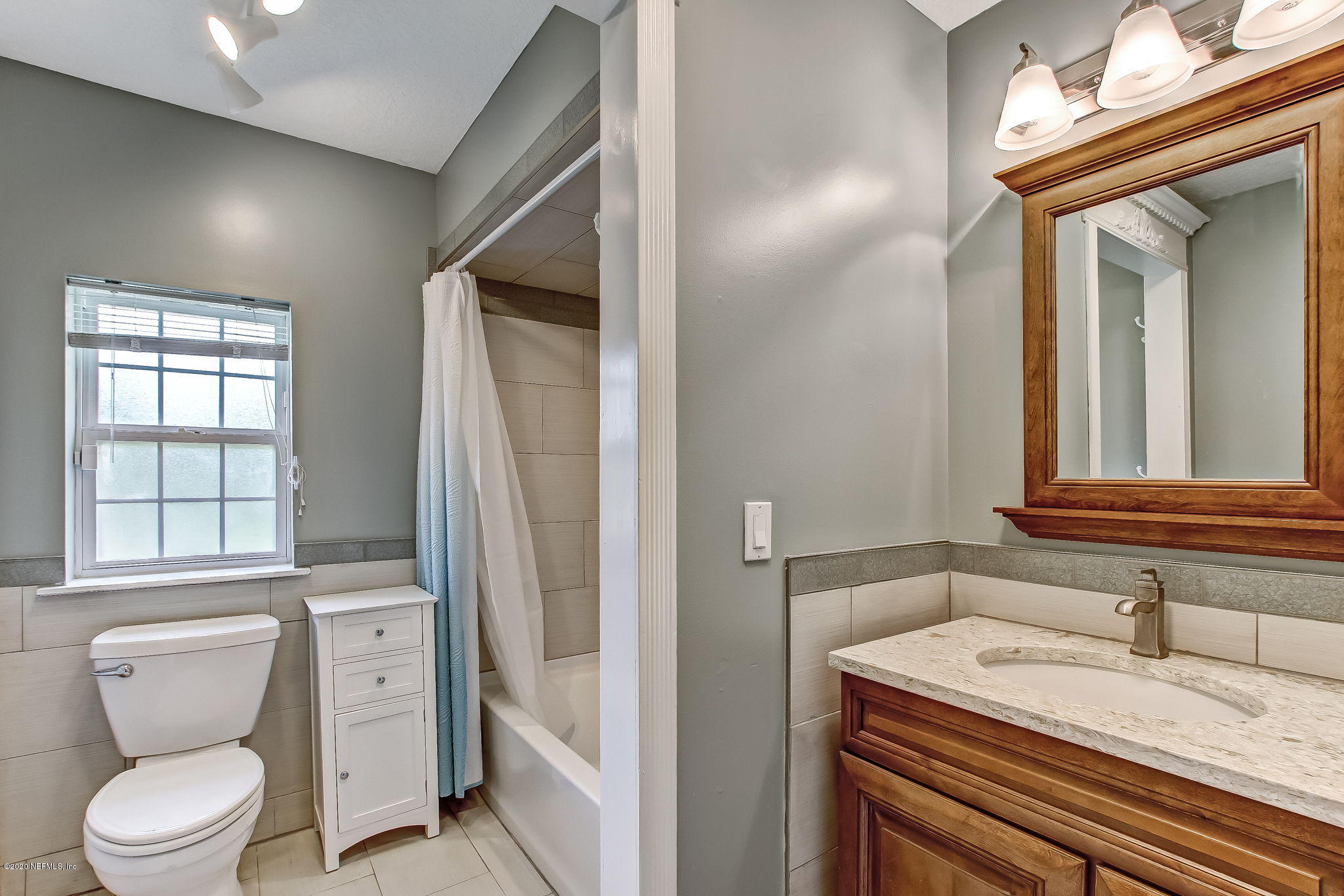 18261 Antler Road Hilliard, FL 32046 - Photo 17 of 32 a bathroom with a granite countertop sink toilet a mirror and shower