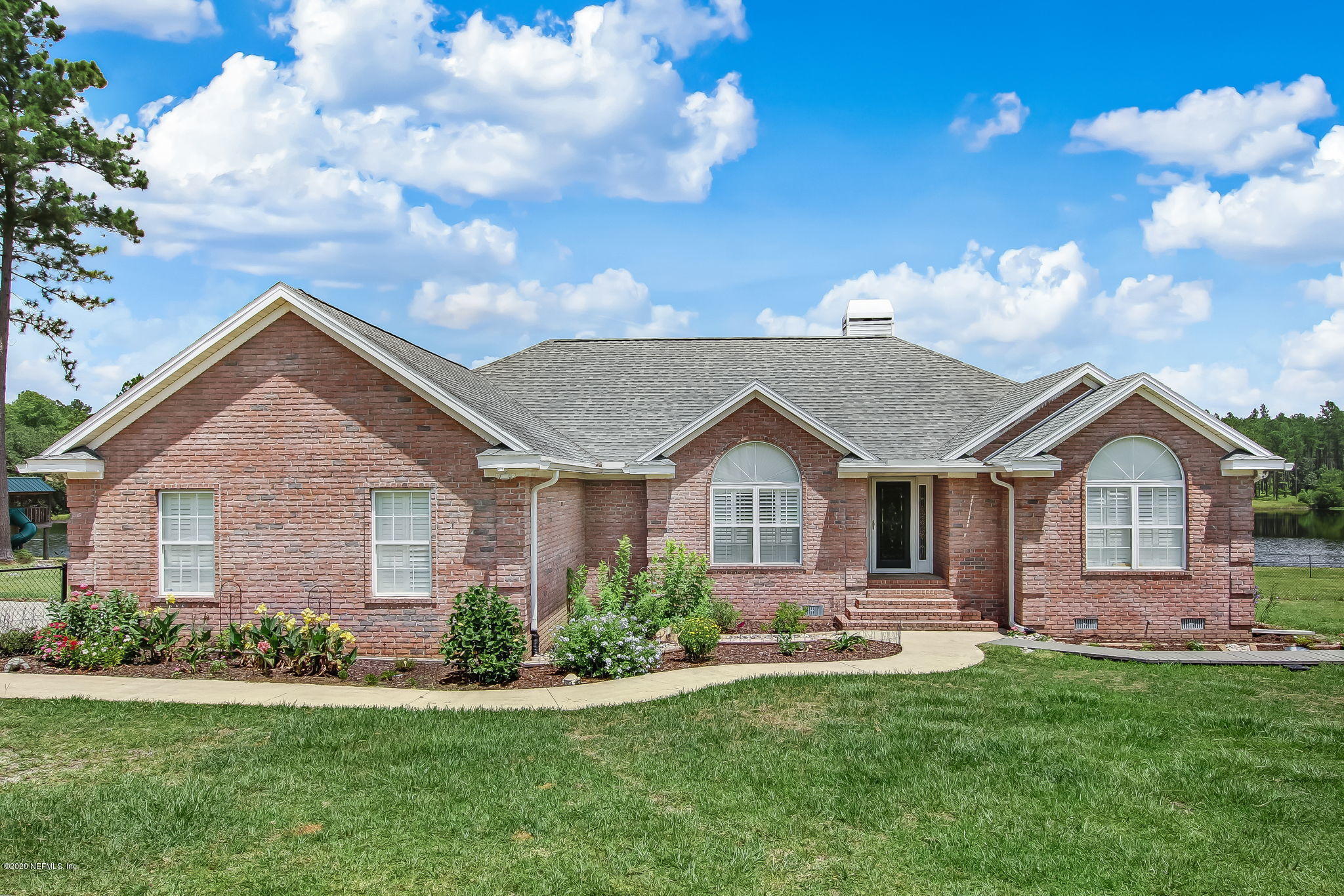 18261 Antler Road Hilliard, FL 32046 - Photo 2 of 32 a front view of a house with a yard