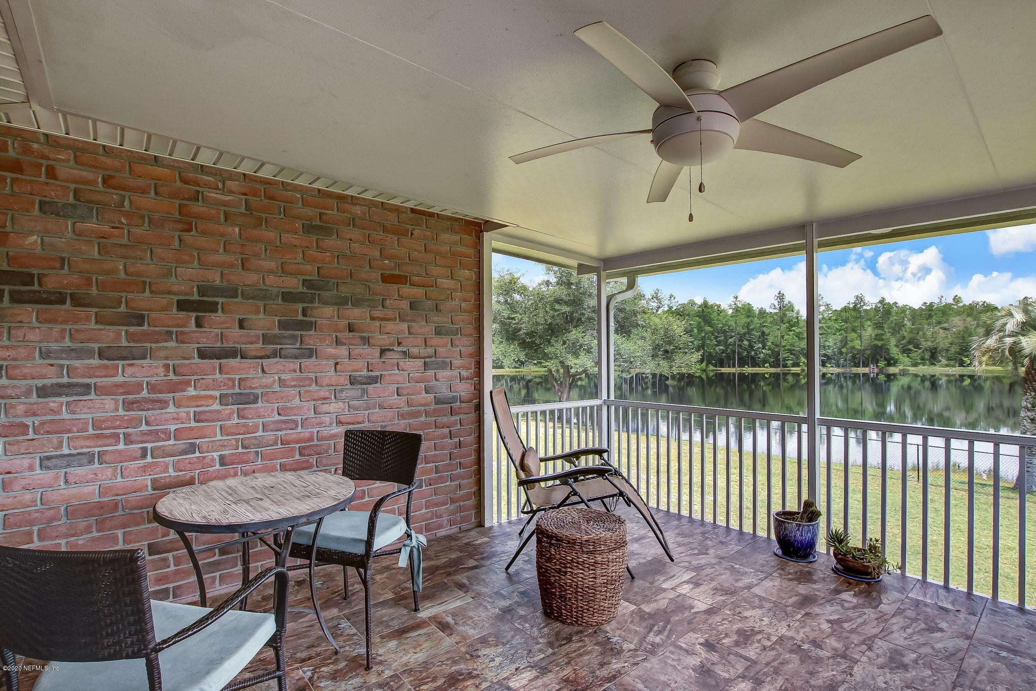 18261 Antler Road Hilliard, FL 32046 - Photo 21 of 32 a view of a porch with furniture and a yard