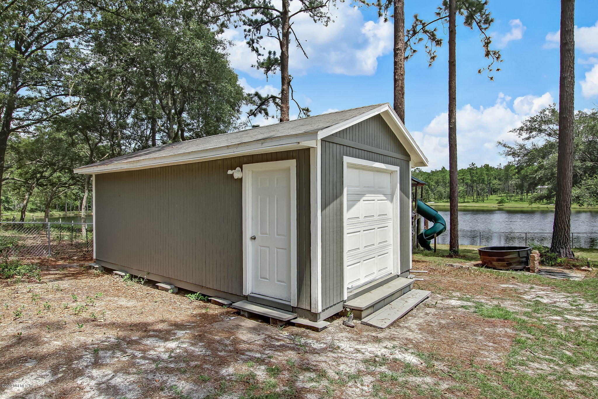 18261 Antler Road Hilliard, FL 32046 - Photo 26 of 32 a view of a small house in the back yard