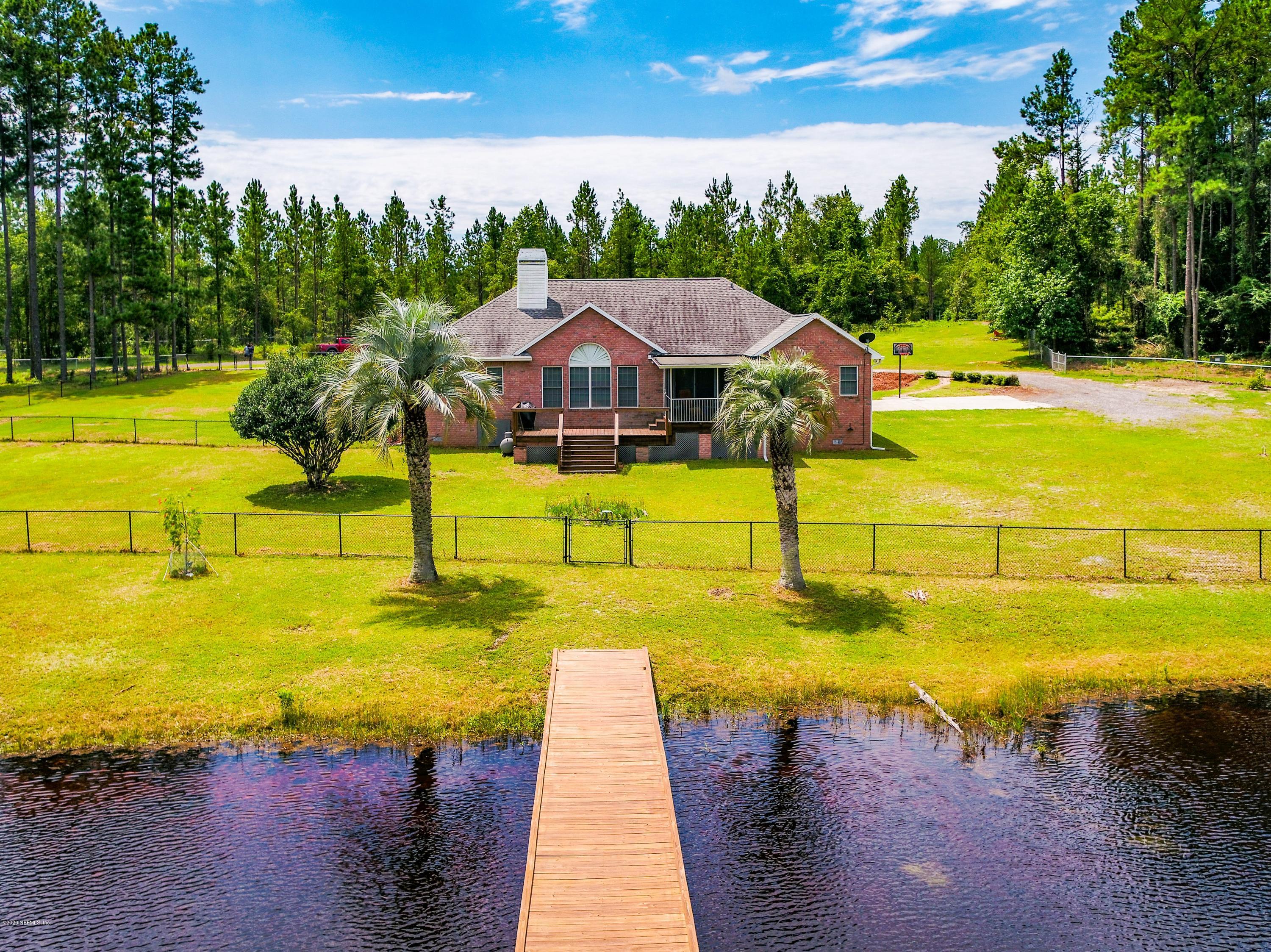 18261 Antler Road Hilliard, FL 32046 - Photo 7 of 32 a view of an swimming pool with an outdoor space and seating area