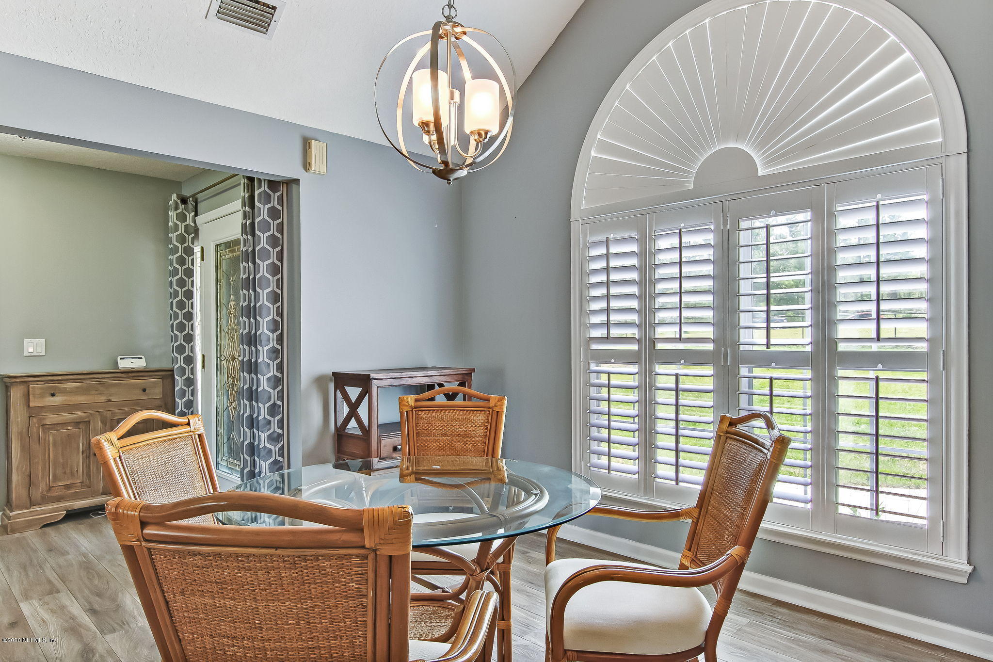 18261 Antler Road Hilliard, FL 32046 - Photo 8 of 32 a dining room with furniture a chandelier and wooden floor