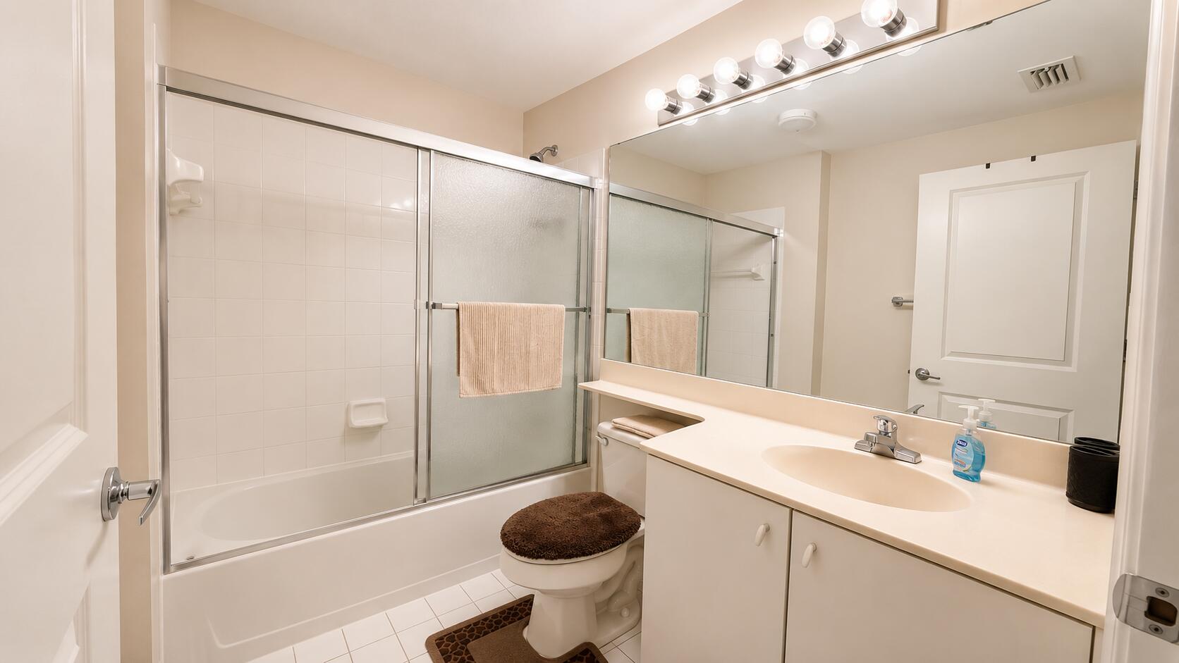 5880 West Sample Road, Unit 105 Coral Springs, FL 33067 - Photo 8 of 17 a bathroom with a sink and a mirror
