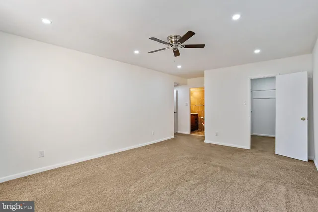 a view of an empty room with a ceiling fan