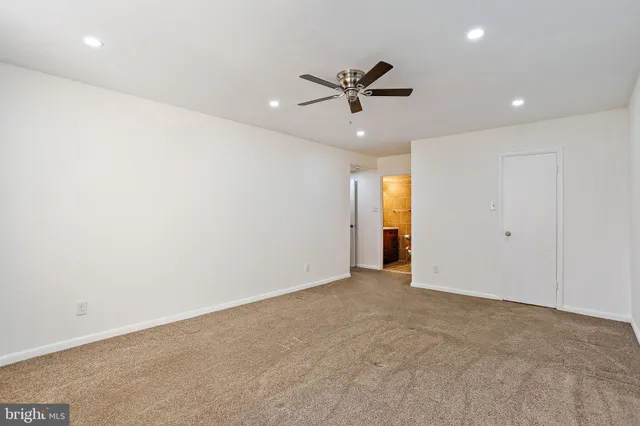 a view of an empty room with a ceiling fan