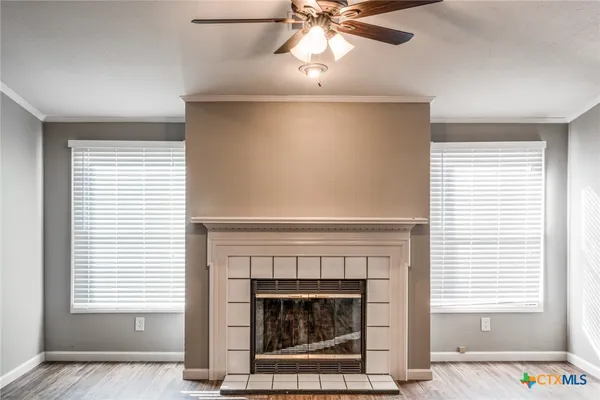 a living room with a fireplace and a window