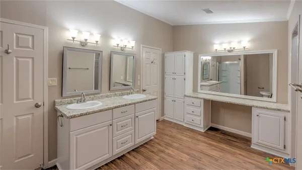 a bathroom with a double vanity sink and mirror