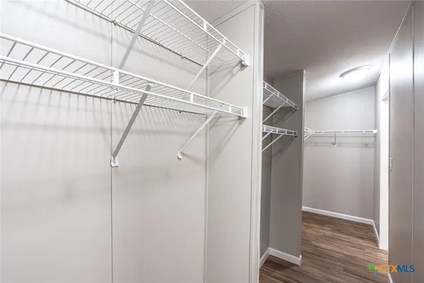 a view of a room with wooden floor