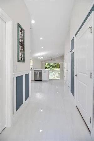 a view of a hallway with closet and a window
