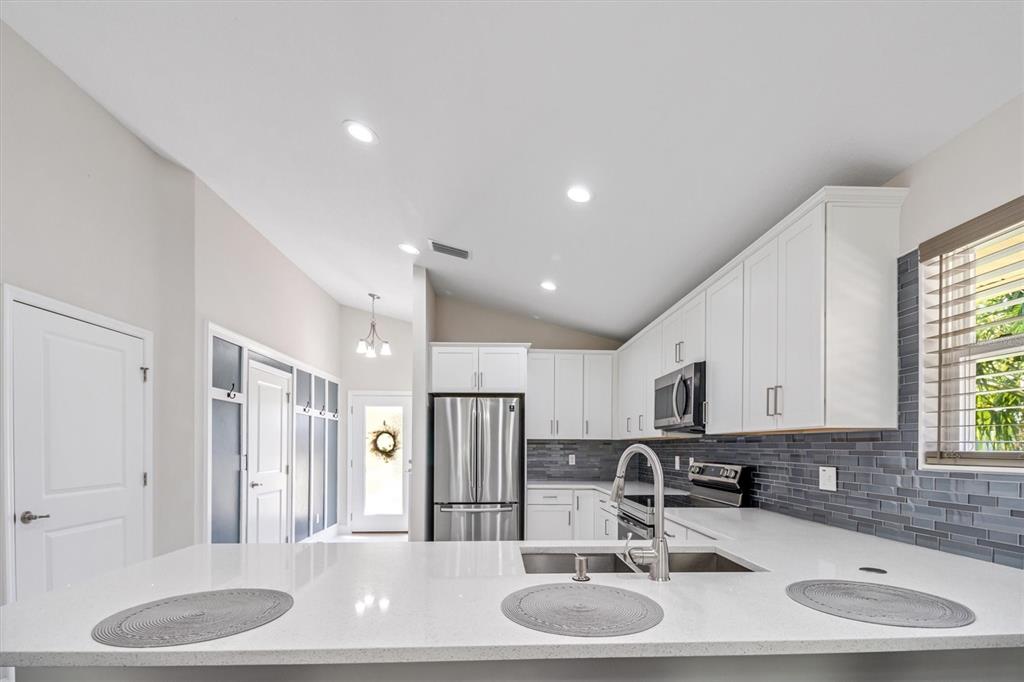 53 Wilmette Avenue Ormond Beach, FL 32174 - Photo 15 of 36 a bathroom with a granite countertop sink and a mirror