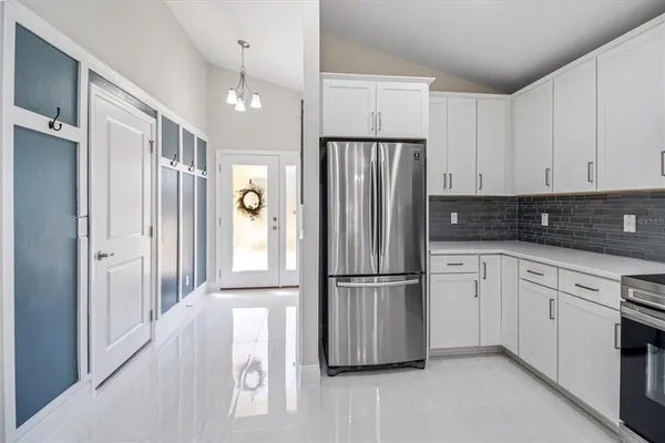 a kitchen with granite countertop a refrigerator and a sink