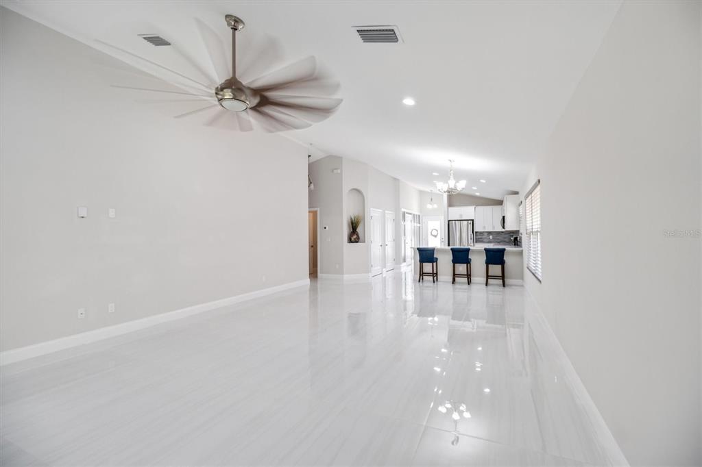 53 Wilmette Avenue Ormond Beach, FL 32174 - Photo 18 of 36 a view of a livingroom with a hardwood floor and a ceiling fan