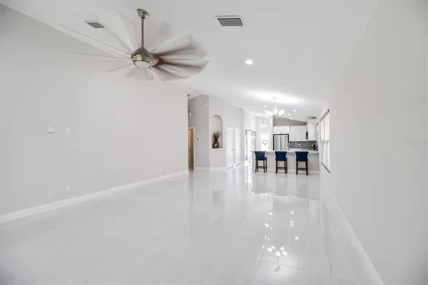 a view of a livingroom with a hardwood floor and a ceiling fan