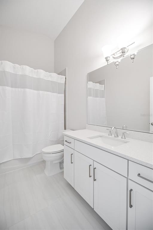 53 Wilmette Avenue Ormond Beach, FL 32174 - Photo 19 of 36 a bathroom with a granite countertop sink a toilet and a mirror