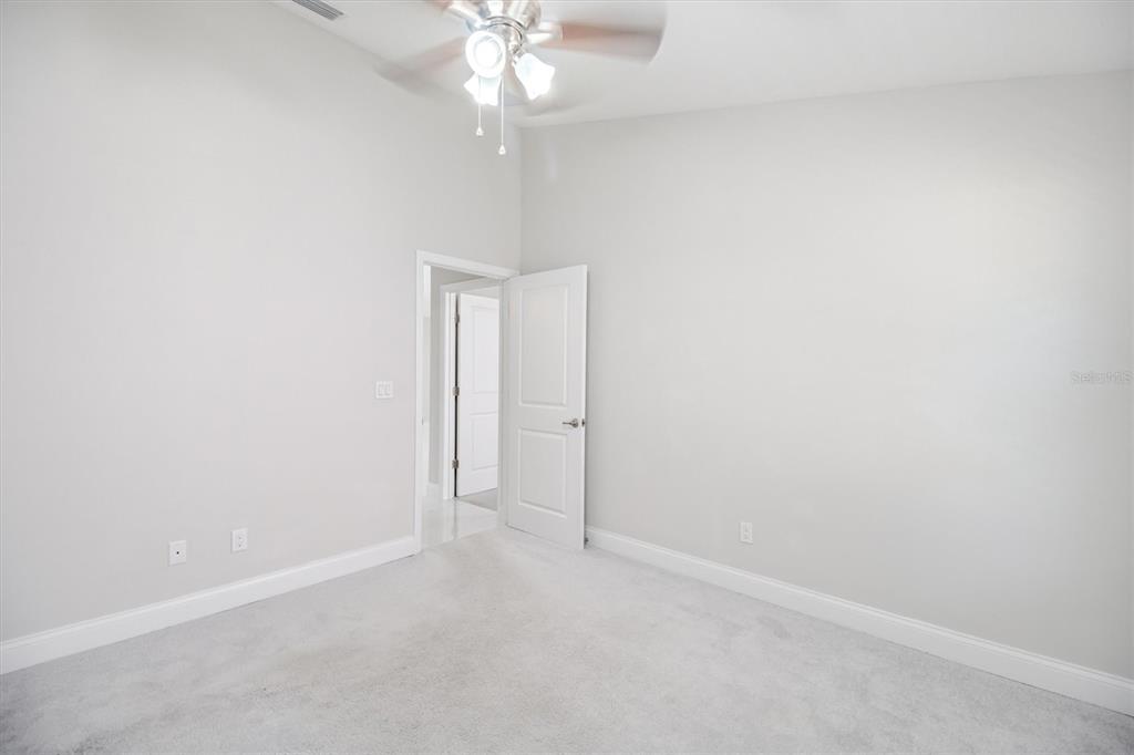 53 Wilmette Avenue Ormond Beach, FL 32174 - Photo 21 of 36 an empty room with a chandelier fan