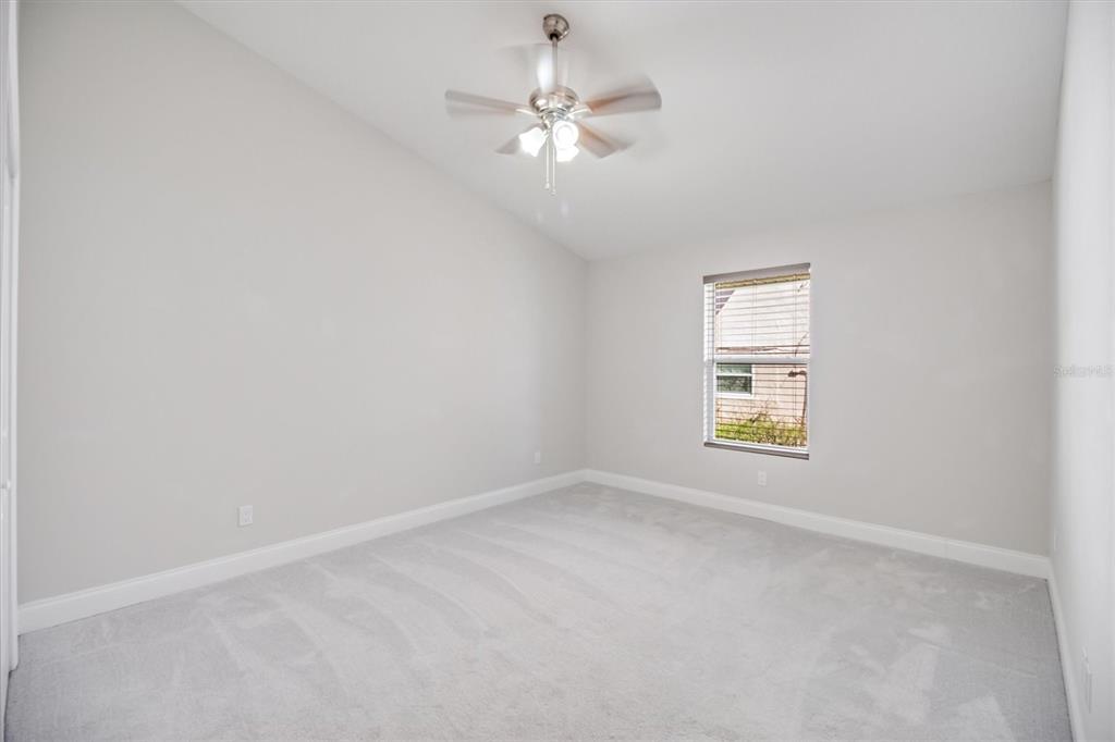 53 Wilmette Avenue Ormond Beach, FL 32174 - Photo 22 of 36 an empty room with a window and a ceiling fan