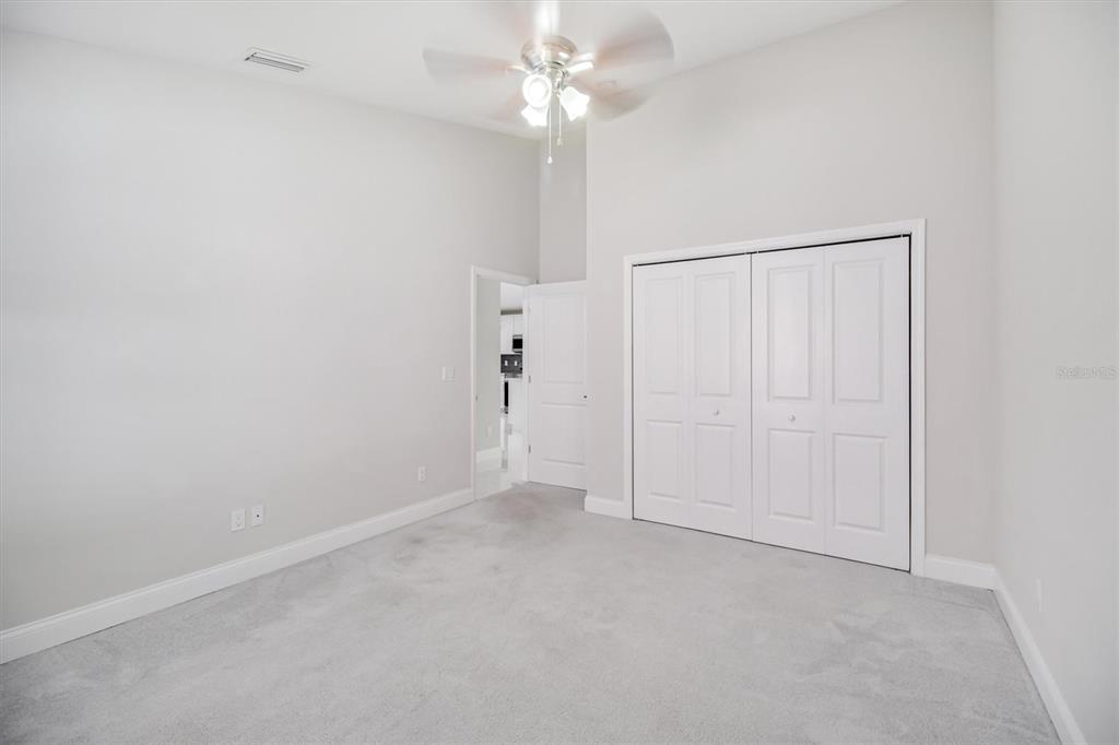 53 Wilmette Avenue Ormond Beach, FL 32174 - Photo 23 of 36 an empty room with a fan & a ceiling fan