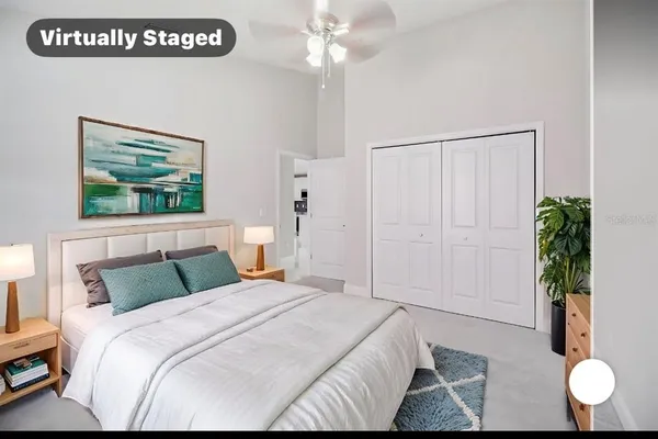 a bedroom with a bed and a potted plant