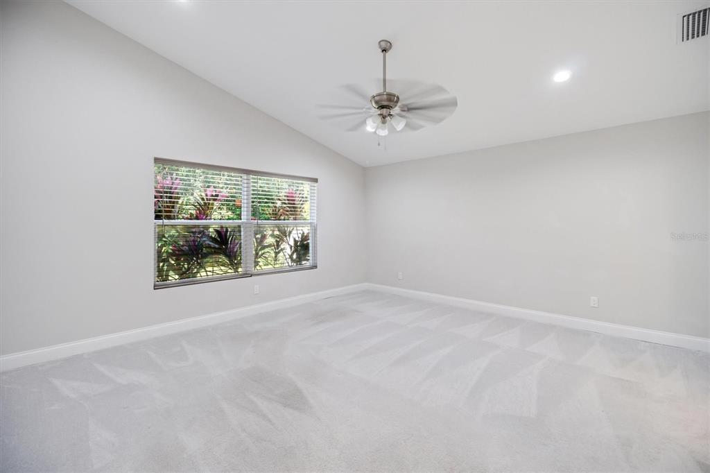 53 Wilmette Avenue Ormond Beach, FL 32174 - Photo 24 of 36 an empty room with windows and ceiling fan