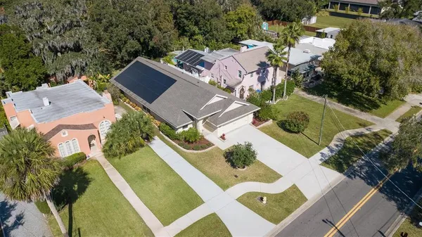 an aerial view of a house with garden space and street view