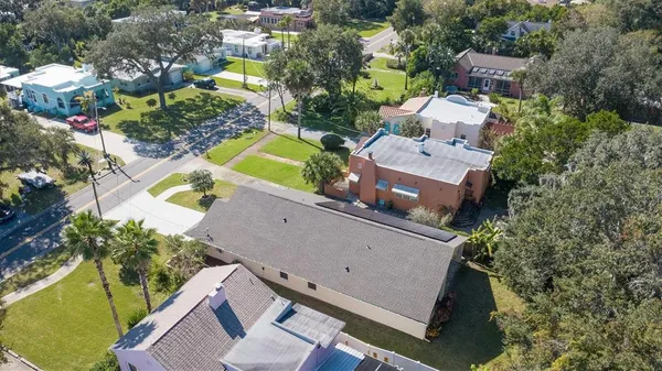 an aerial view of a house with a swimming pool and outdoor space