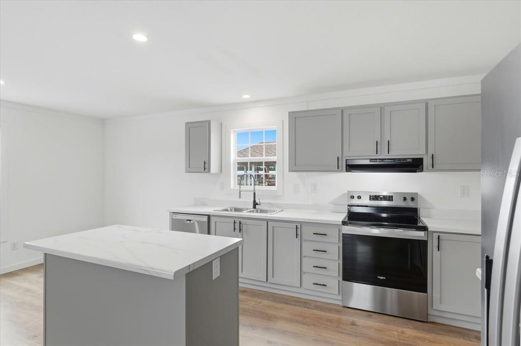 9128 Scepter Avenue Brooksville, FL 34613 - Photo 19 of 44 a kitchen with a sink stove and cabinets