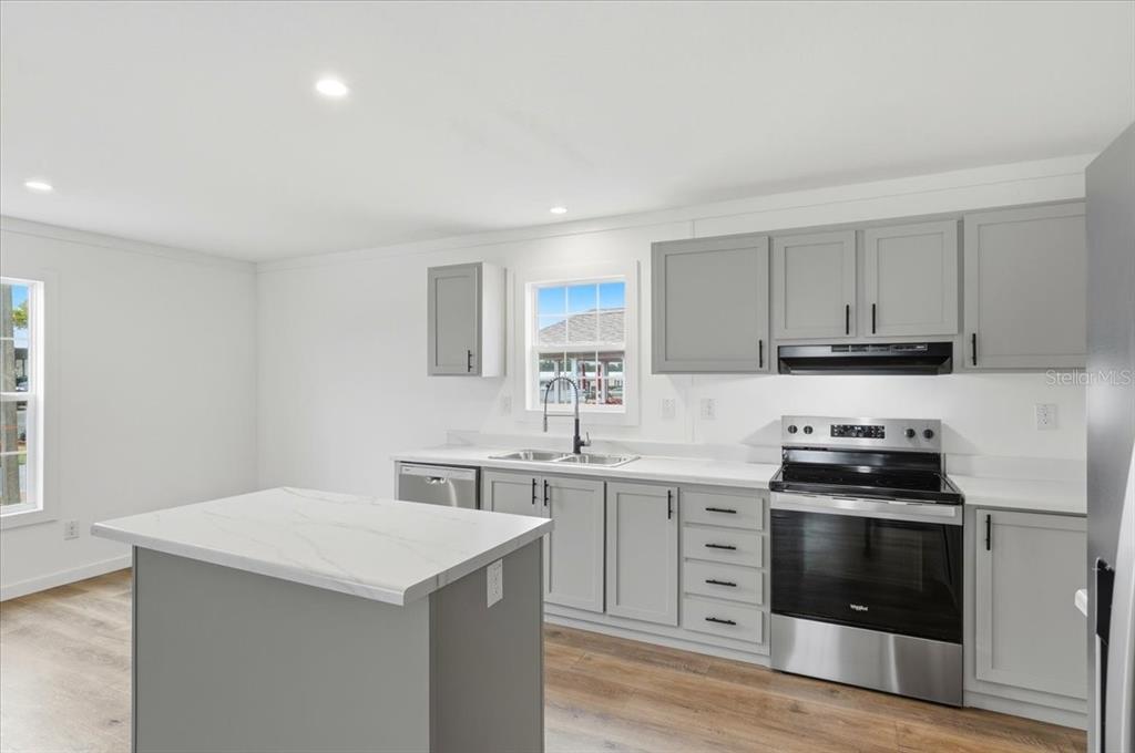 9128 Scepter Avenue Brooksville, FL 34613 - Photo 20 of 44 a kitchen with a stove and a sink