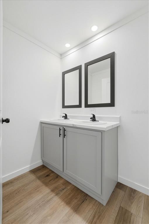 9128 Scepter Avenue Brooksville, FL 34613 - Photo 26 of 44 a view of an empty room with wooden floor and cabinet