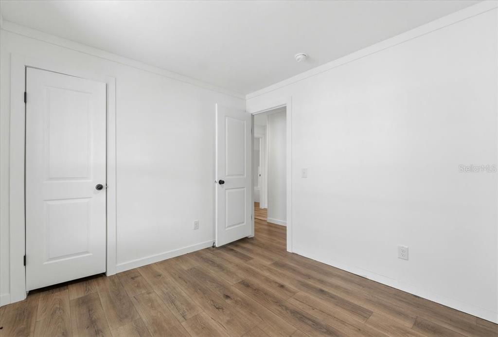 9128 Scepter Avenue Brooksville, FL 34613 - Photo 30 of 44 a view of an empty room with wooden floor