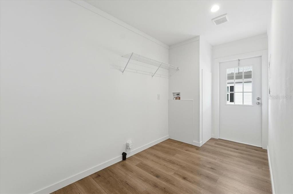 9128 Scepter Avenue Brooksville, FL 34613 - Photo 33 of 44 a view of a room with wooden floor and closet