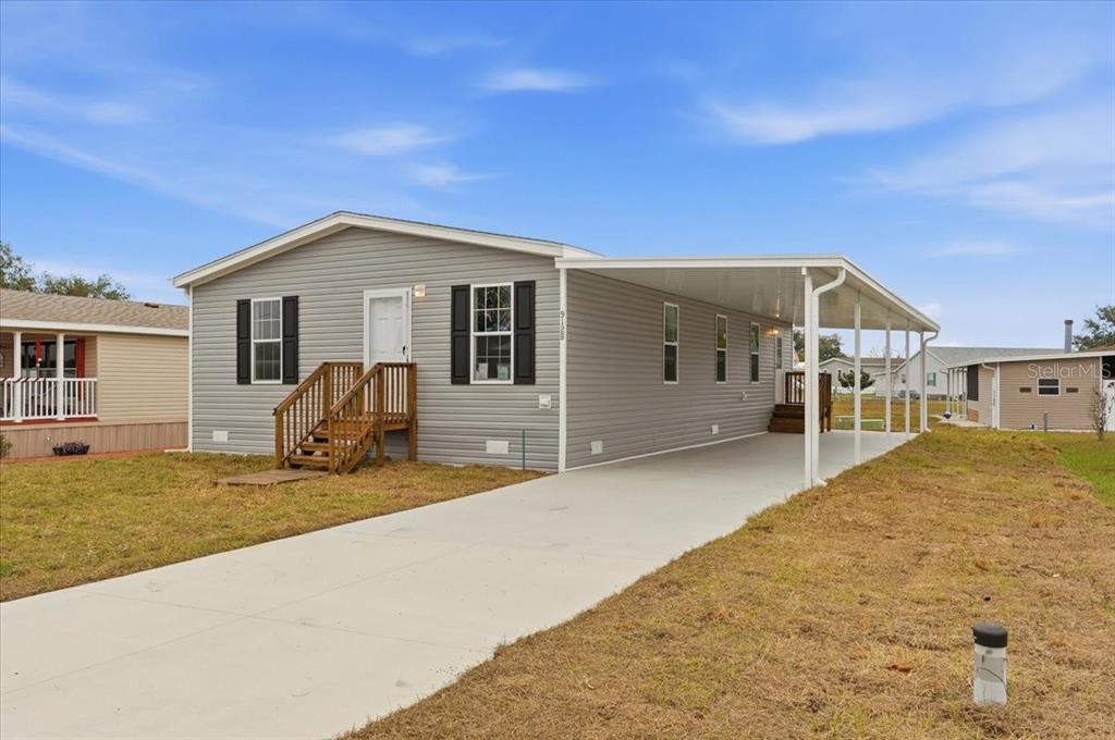 9128 Scepter Avenue Brooksville, FL 34613 - Photo 4 of 44 a front view of a house with a yard