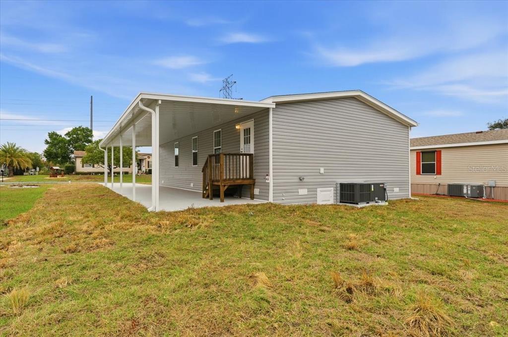 9128 Scepter Avenue Brooksville, FL 34613 - Photo 7 of 44 a view of a house with backyard and garden
