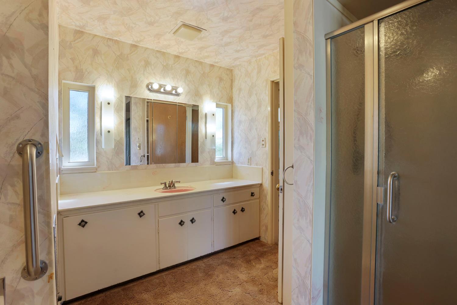 2465 Vernalis Road Tracy, CA 95304 - Photo 19 of 55 a spacious bathroom with a granite countertop sink a mirror and a shower