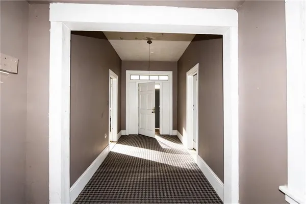 a view of a hallway with wooden floor