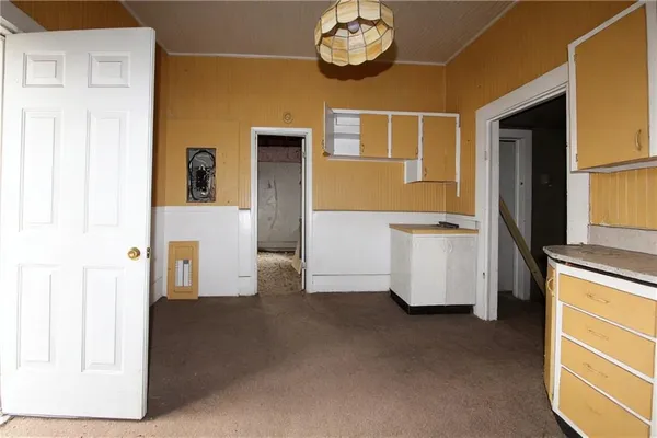 a view of a room with a kitchen