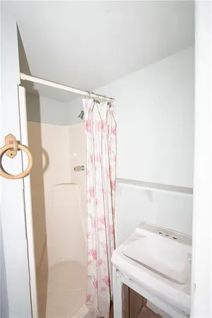 a bathroom with a sink a toilet and shower curtain