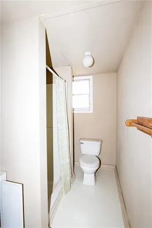 a bathroom with a toilet and a shower