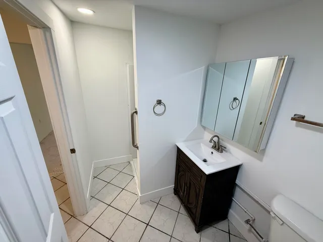 a bathroom with a sink vanity and a mirror