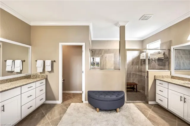 a spacious bathroom with a granite countertop sink and a mirror