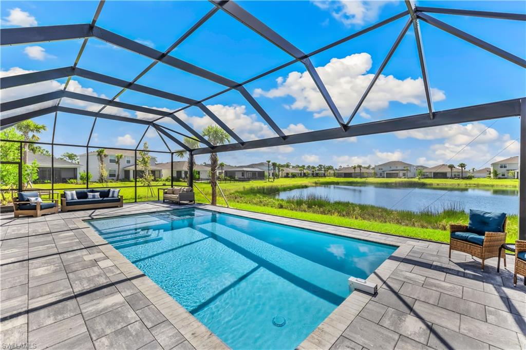 43693 Tree Top Trail Babcock Ranch, FL 33982 - Photo 2 of 25 a view of swimming pool with outdoor seating and yard