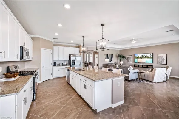 a kitchen with stainless steel appliances granite countertop a sink and cabinets
