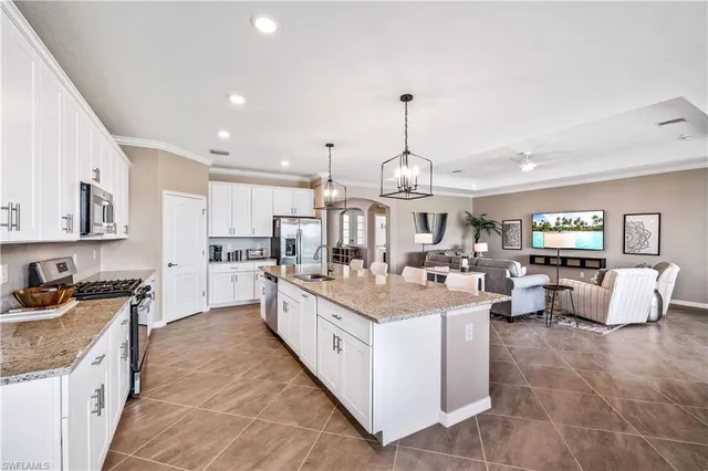 a kitchen with stainless steel appliances granite countertop a sink and cabinets