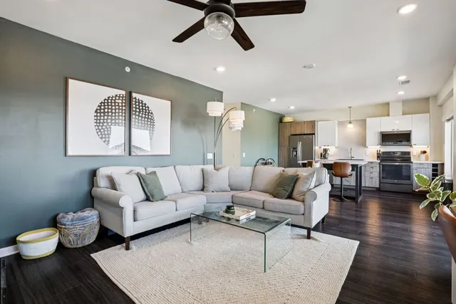 a living room with furniture and a wooden floor