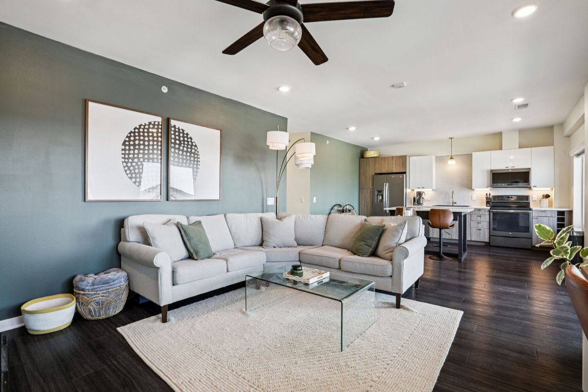 a living room with furniture and a wooden floor