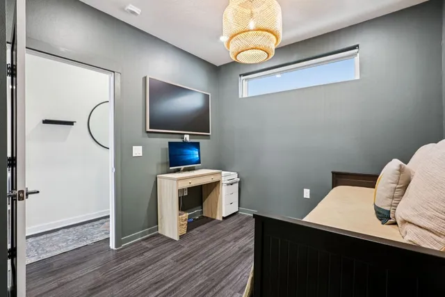 a room with a bed and a book shelf