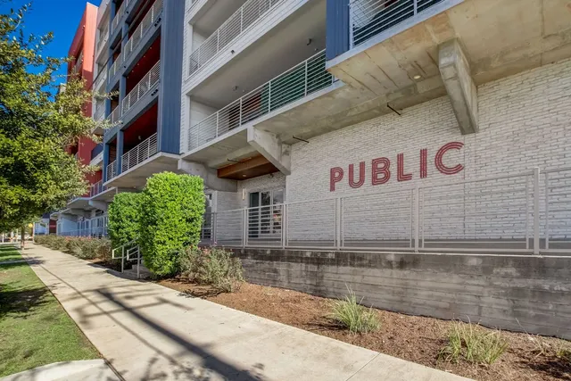 a view of a street with potted plants