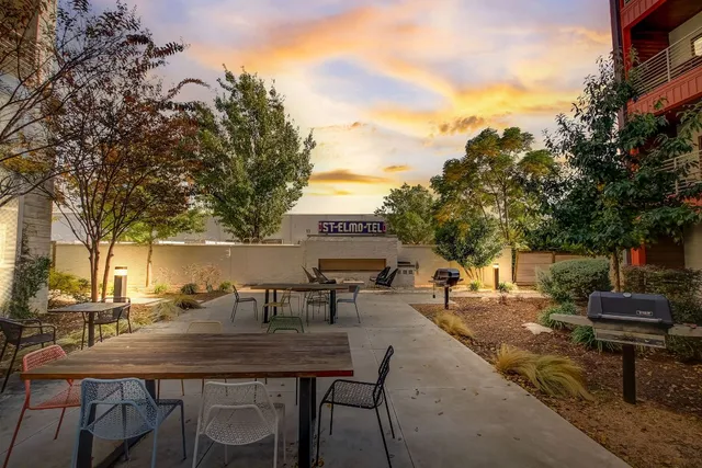 a view of a patio with table and chairs and potted plants