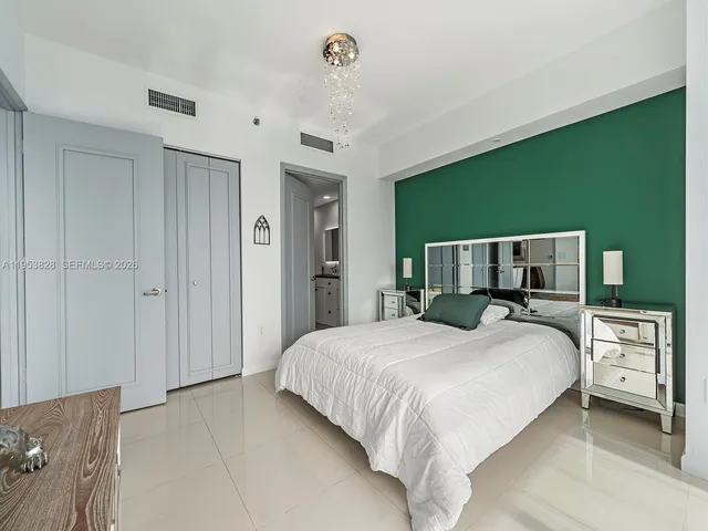 a bedroom with a bed and a chandelier